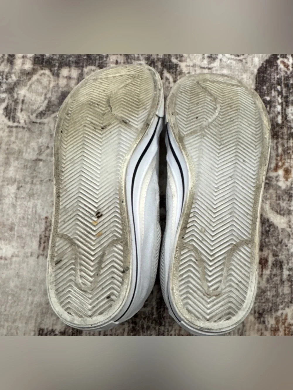 Nike Women’s White Slip-On Sneakers with Black Swoosh Accent